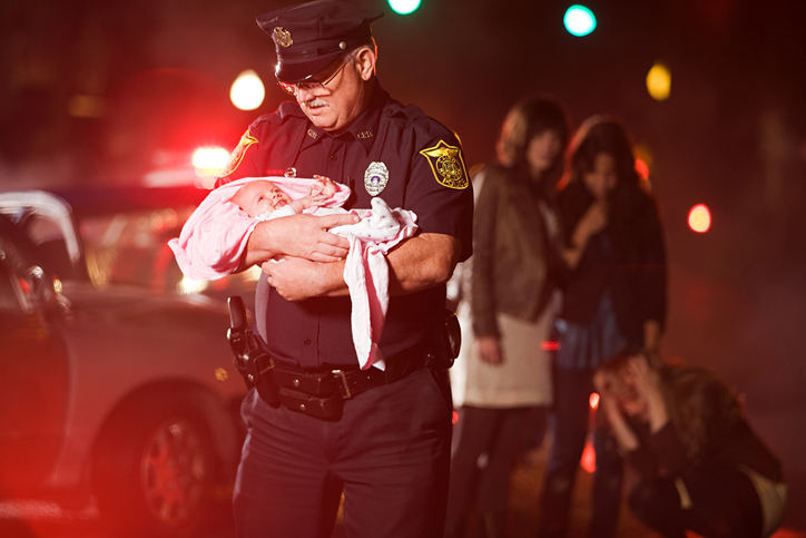 Police officer holding a baby